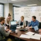 An IT team around a conference table listening to a speaker present an SAP Project Workflow whiteboard.